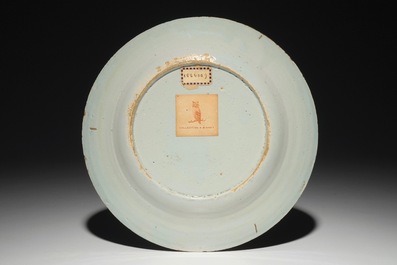 A fine Dutch Delft mixed technique plate with a central flowervase, 18th C.